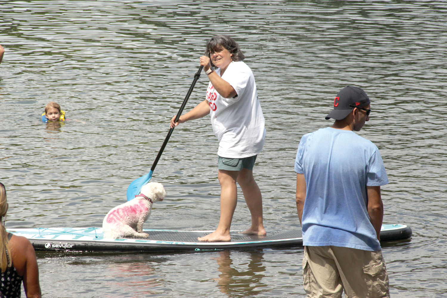 ALL ABOARD: Pond neighbor Alisa Richardson not only had her dog along for the Palozza, but it was also expressing the aim to save the pond.